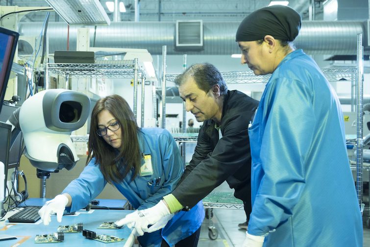 3 DSM staff members working together in our manufacturing facility.