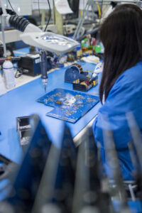 Soldering technician applying IPC-A-610 Class 2 and Class 3 workmanship standards during PCB assembly at Dynamic Source Manufacturing.